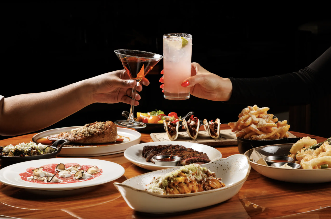Guests toasting cocktails over the table